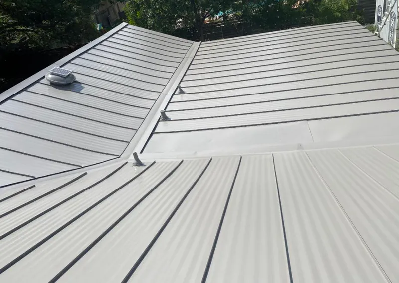 Solar attic fan installed on a metal roof for Roof Ventilation in Independence